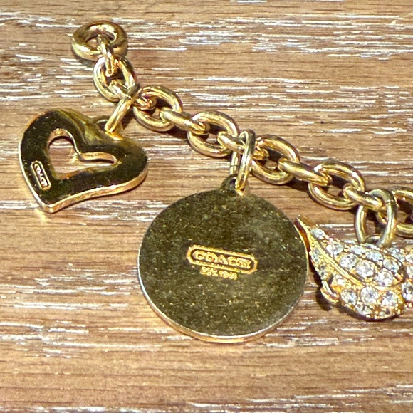 Coach Gold Tone Multi Charm Bracelet. Includes locket Heart, Bird, Star and more - Picture 12 of 17